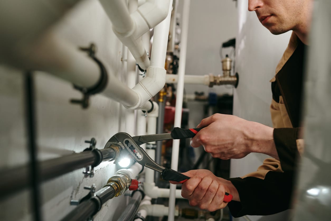Plumbers maintaining commercial plumbing pipes in Casa Grande