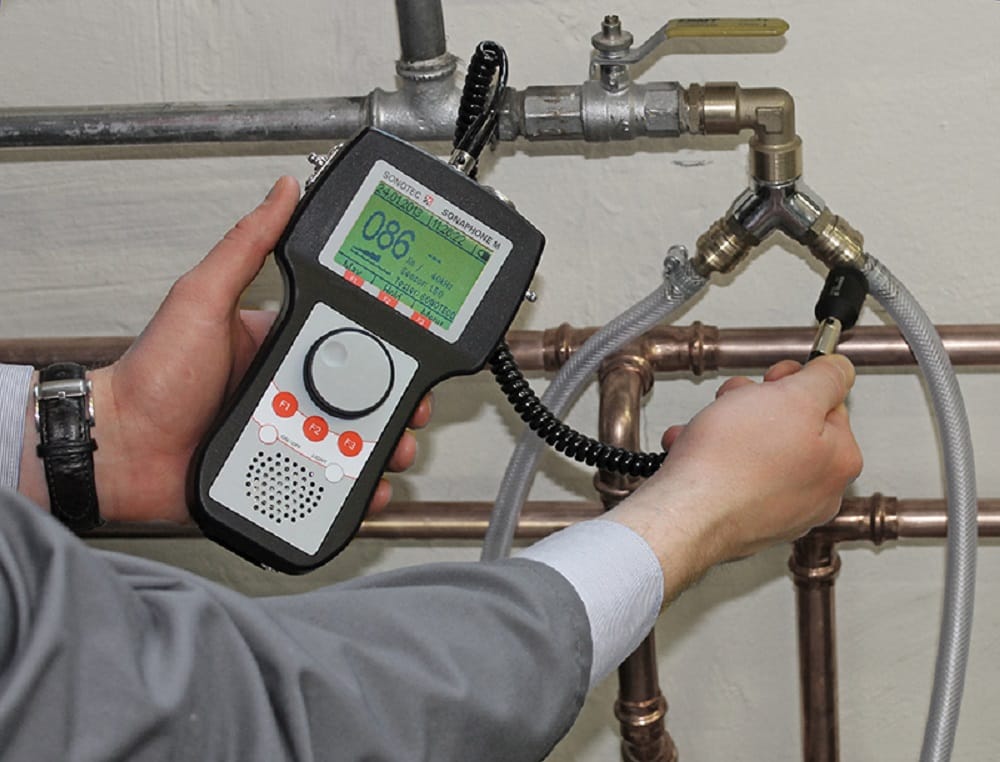 Plumber testing pipes with electronic leak detection equipment in Casa Grande