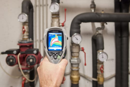 Plumber using a thermal imaging camera to inspect pipes in Casa Grande