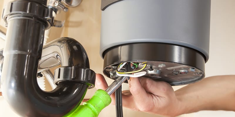 Technician repairing the heating element of a water heater in Casa Grande