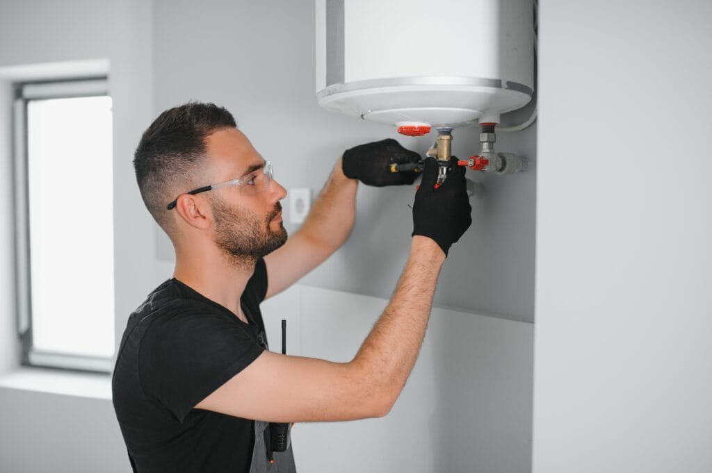 Technician performing water heater maintenance in Casa Grande